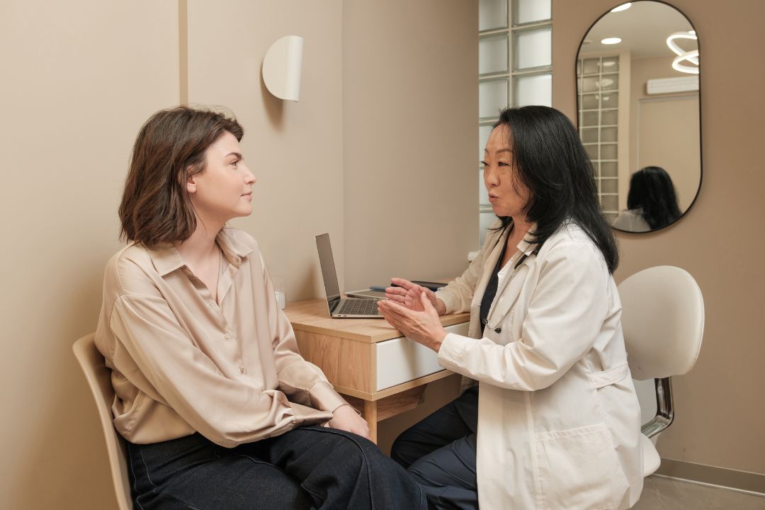 A patient talking with a clinician in a calm consulting room